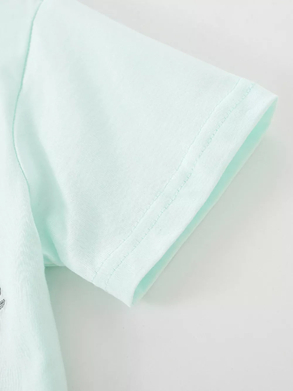 Light blue baby polo shirt with embroidered animal detail on chest