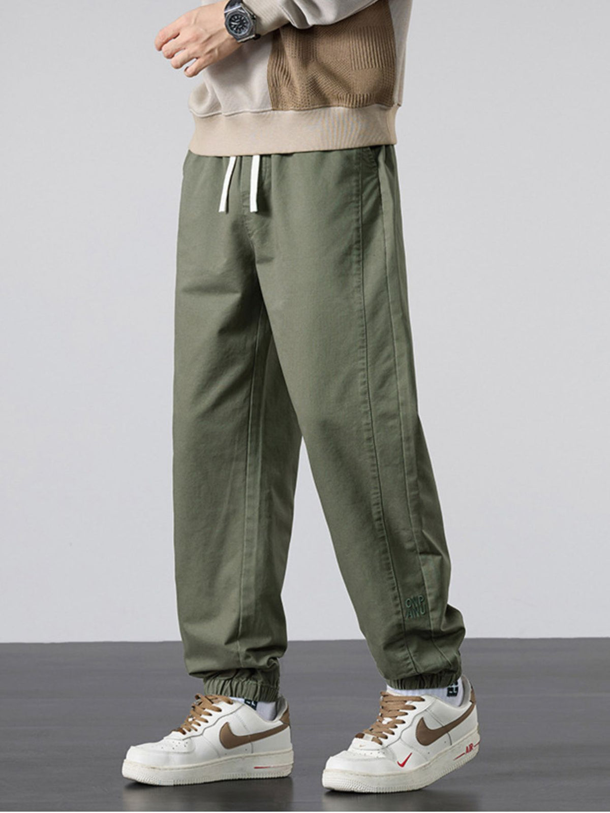 joggers in olive green featuring drawstring waist and loose fit