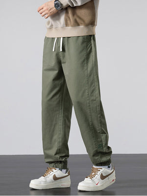 joggers in olive green featuring drawstring waist and loose fit