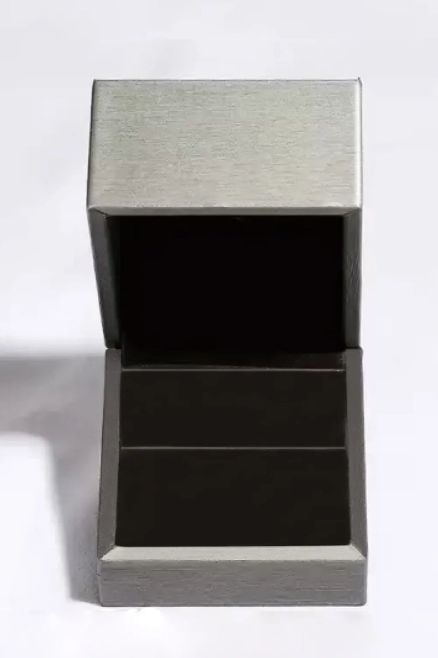 Silver ring box with open lid and dark interior.
