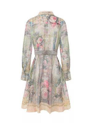Pastel floral print button-down shirt dress with a belted waist and long sleeves.