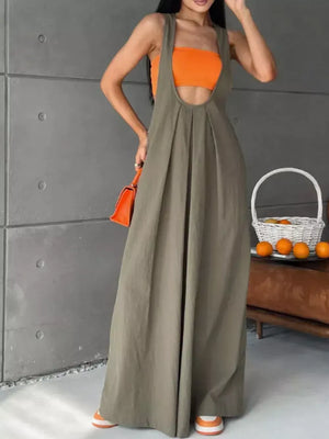 Army green pleated overall maxi dress with pockets, worn with an orange crop top.