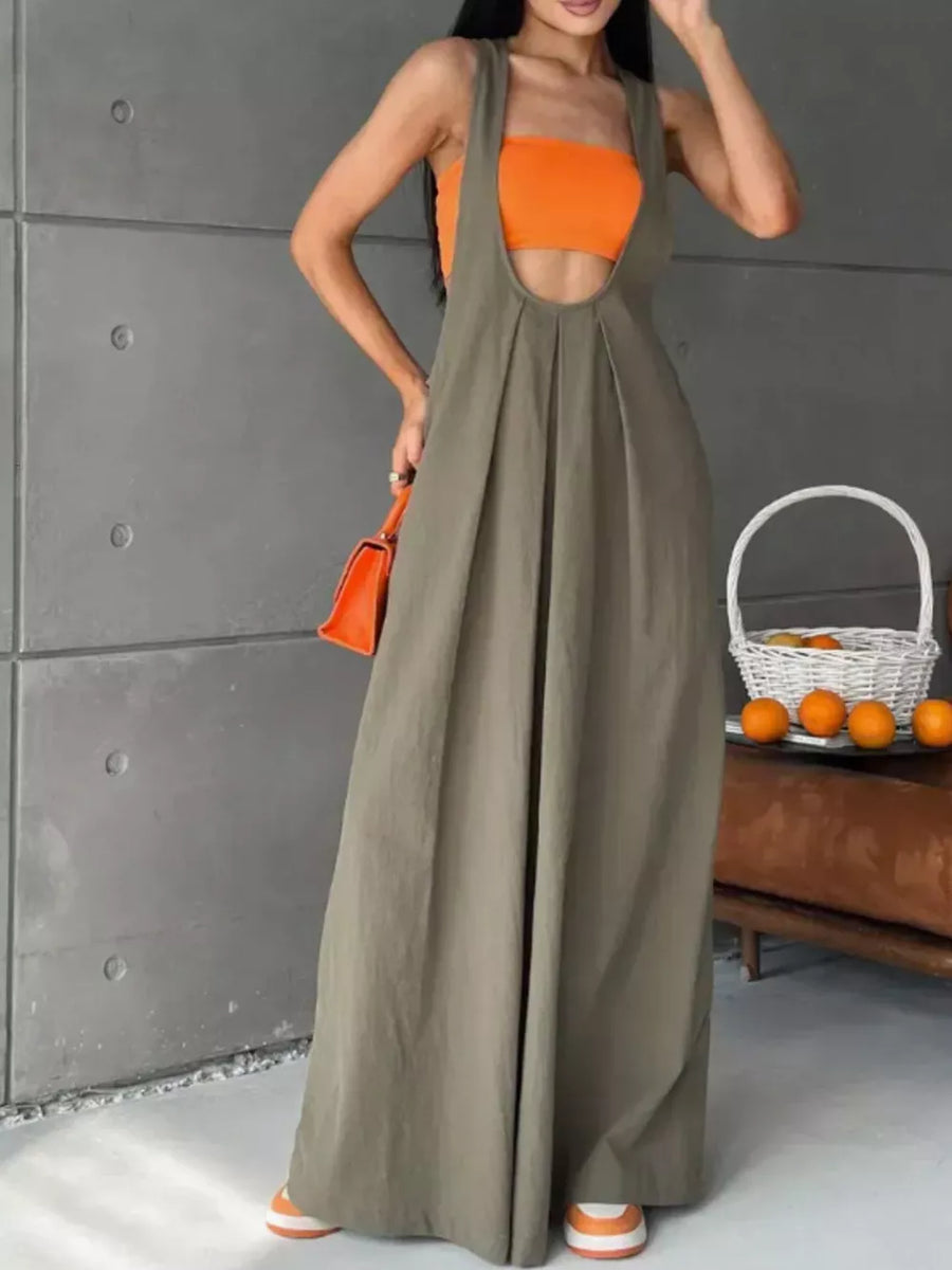 Army green pleated overall maxi dress with pockets, worn with an orange crop top.