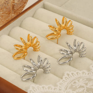Sculptural petal drop earrings in gold and silver with unique layered design.