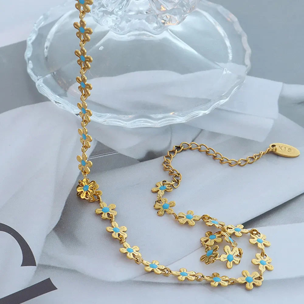 Gold daisy chain enamel petal necklace with turquoise centers