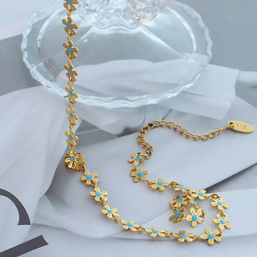 Gold daisy chain enamel petal necklace with turquoise centers