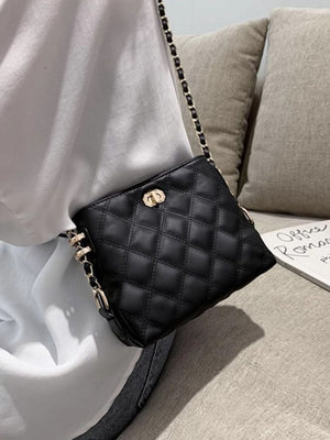 Black quilted PU leather crossbody bag with gold chain strap and clasp detail.