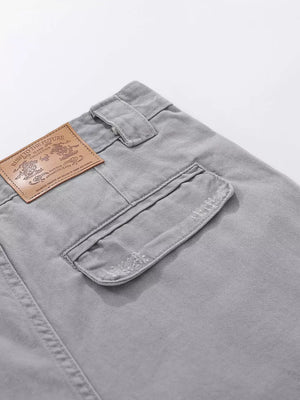 Grey cargo capris with distressed pocket detail and leather patch.