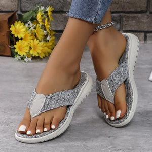 Textured gray thong sandals with cushioned sole and white toenails.