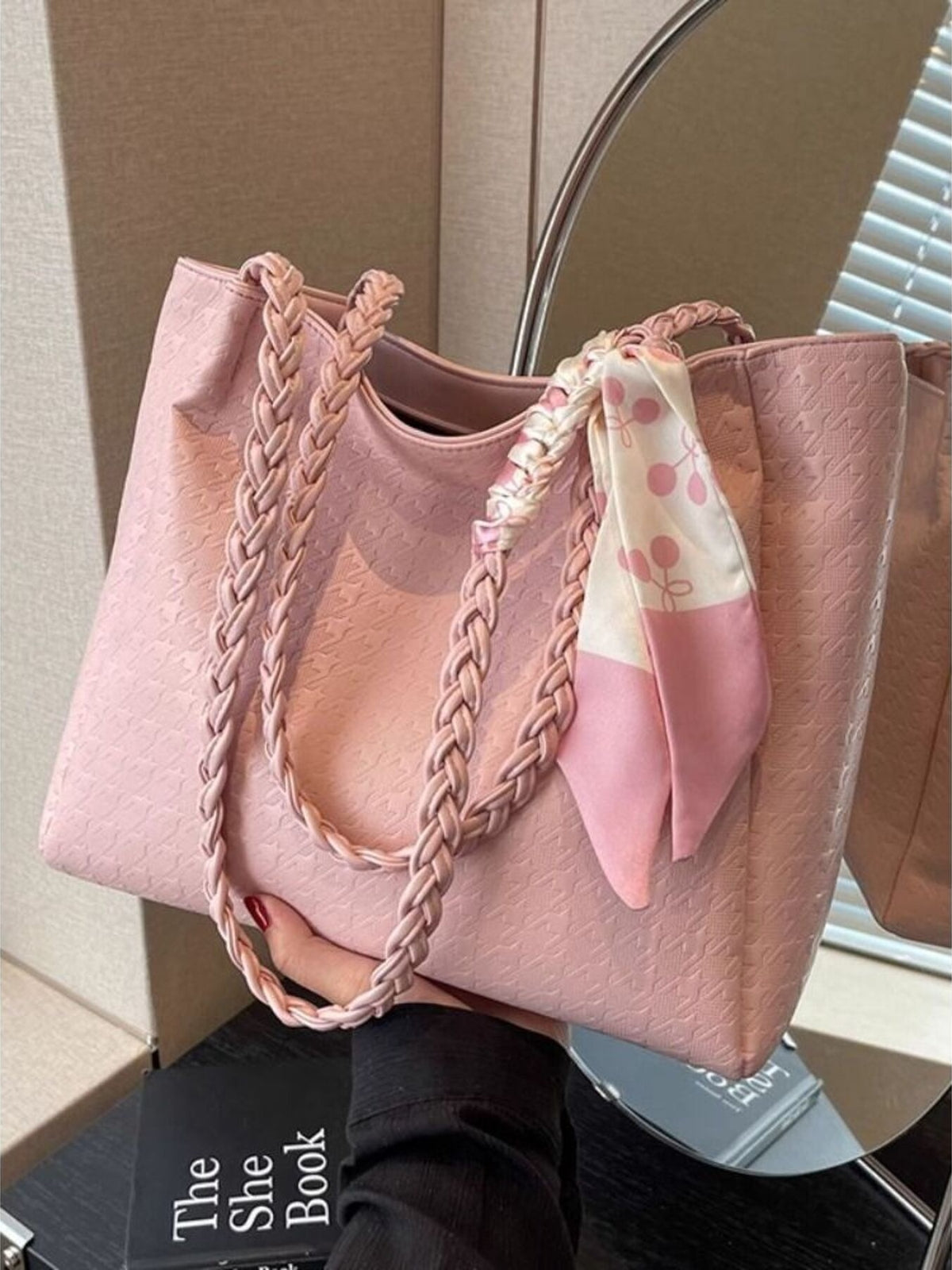 Blush pink tote bag with braided handles and a patterned scarf accent