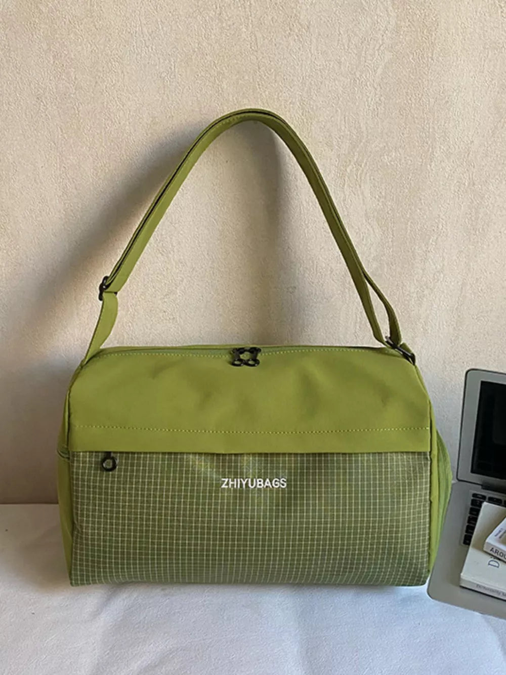 Green plaid Oxford travel bag with adjustable strap and zip closure.