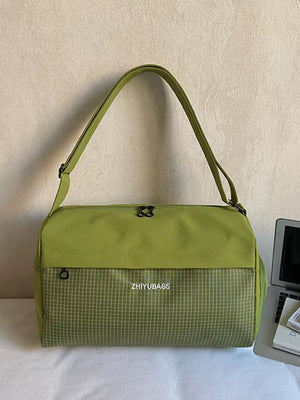 Green plaid Oxford travel bag with adjustable strap and zip closure.