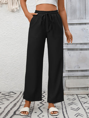 Black drawstring wide-leg pants with elastic waist and patch pockets.