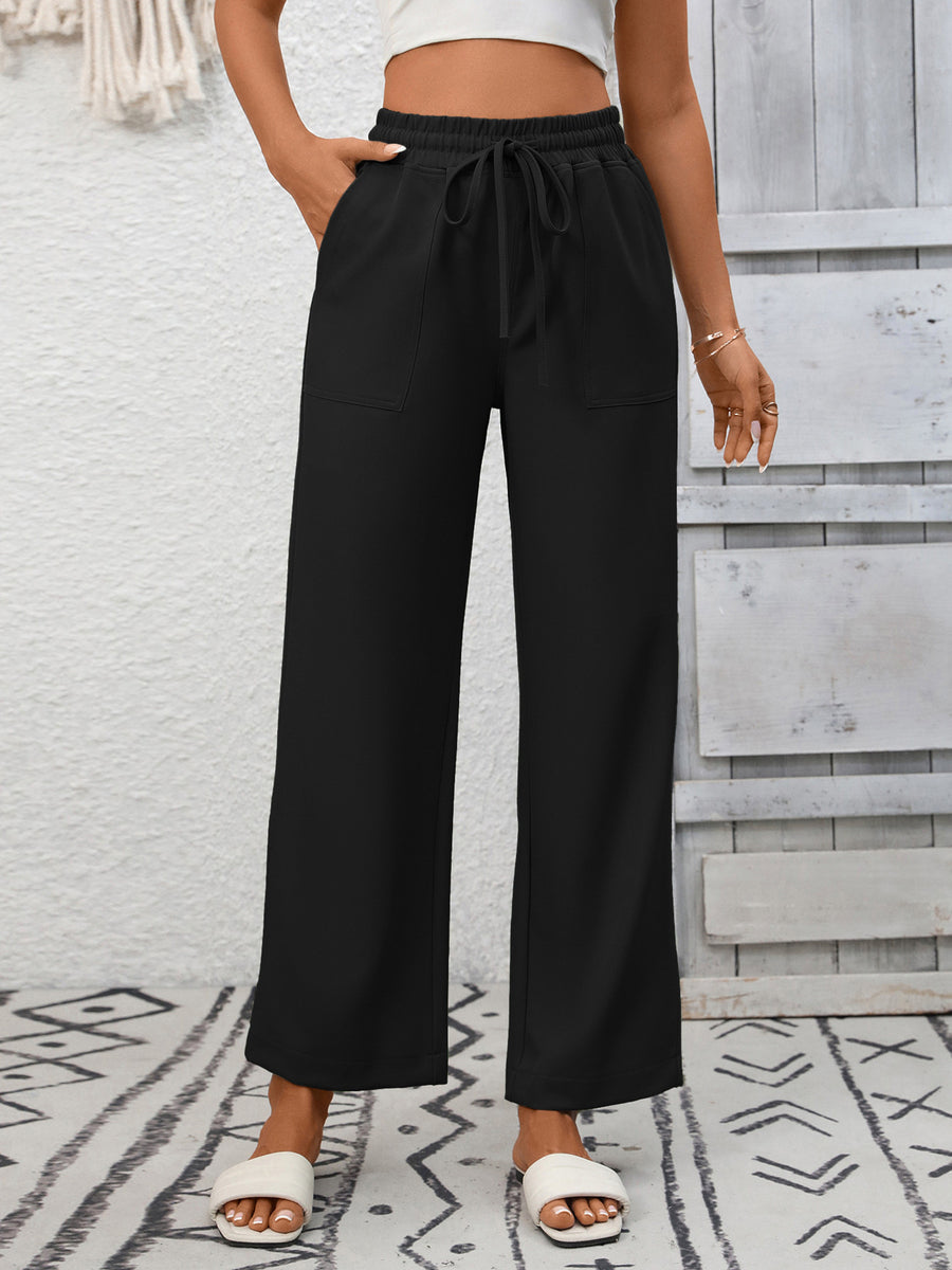 Black drawstring wide-leg pants with elastic waist and patch pockets.