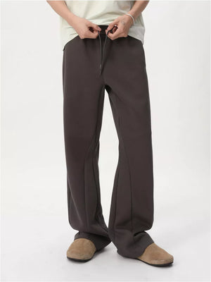 Relaxed fit dark gray sweatpants with adjustable drawstring waist and flared leg.