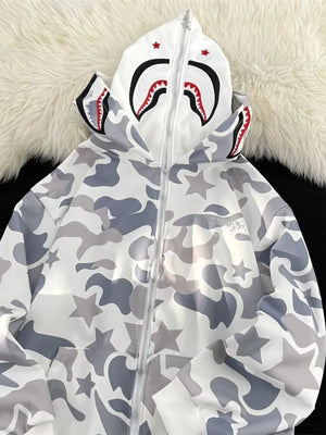 Off-white camo print zip-up hoodie with shark graphic on hood and star details.