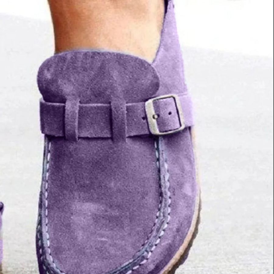 Purple suede buckle mule loafers with contrast stitching and a silver buckle detail.