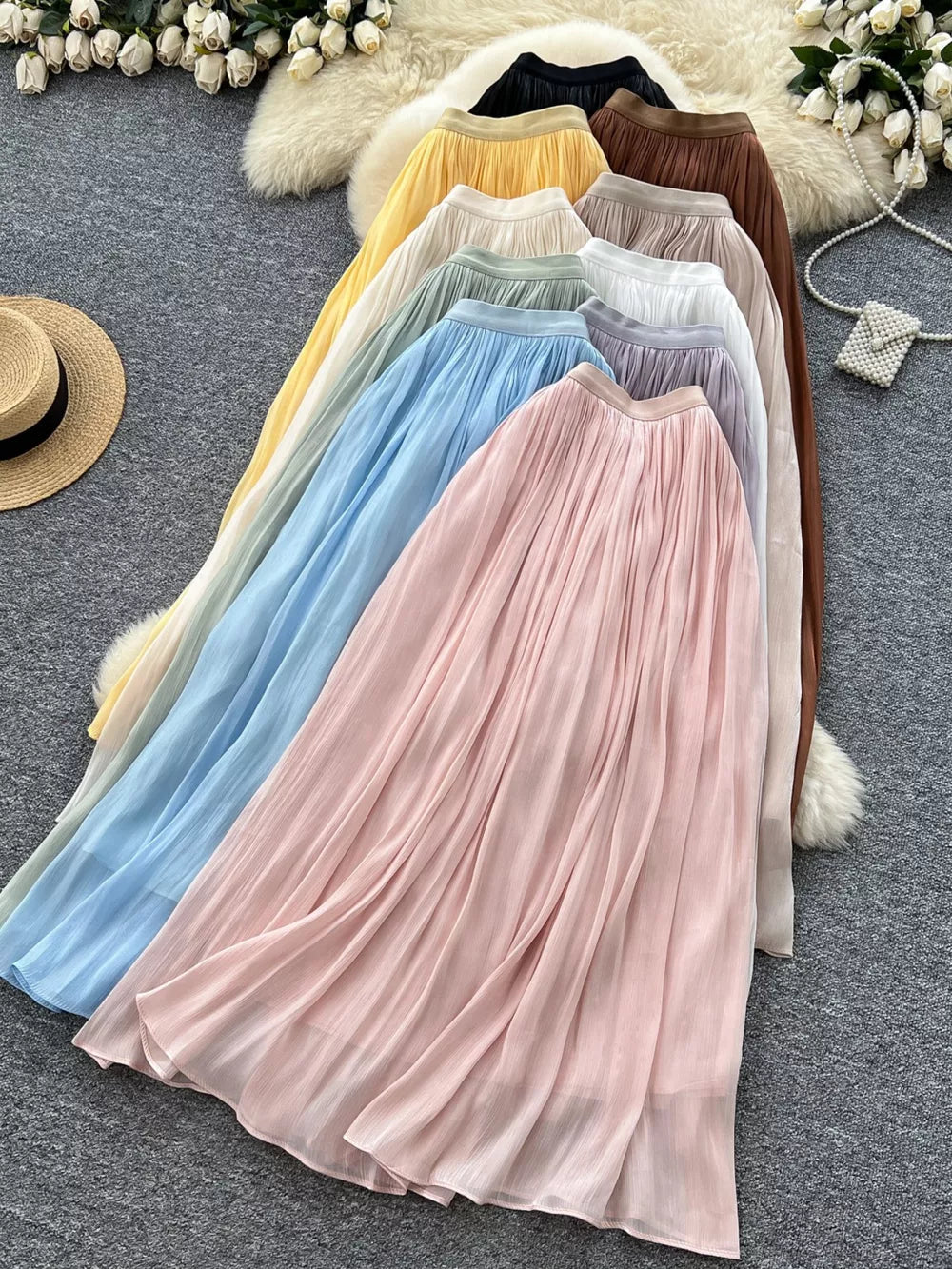 Pleated maxi skirts in brown, apricot, blue, cream, purple, white, light green, pink, black, and yellow.
