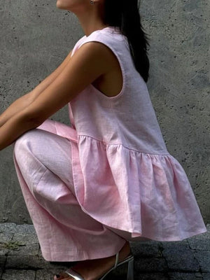 Blush pink sleeveless peplum top and wide-leg pants set in cotton.