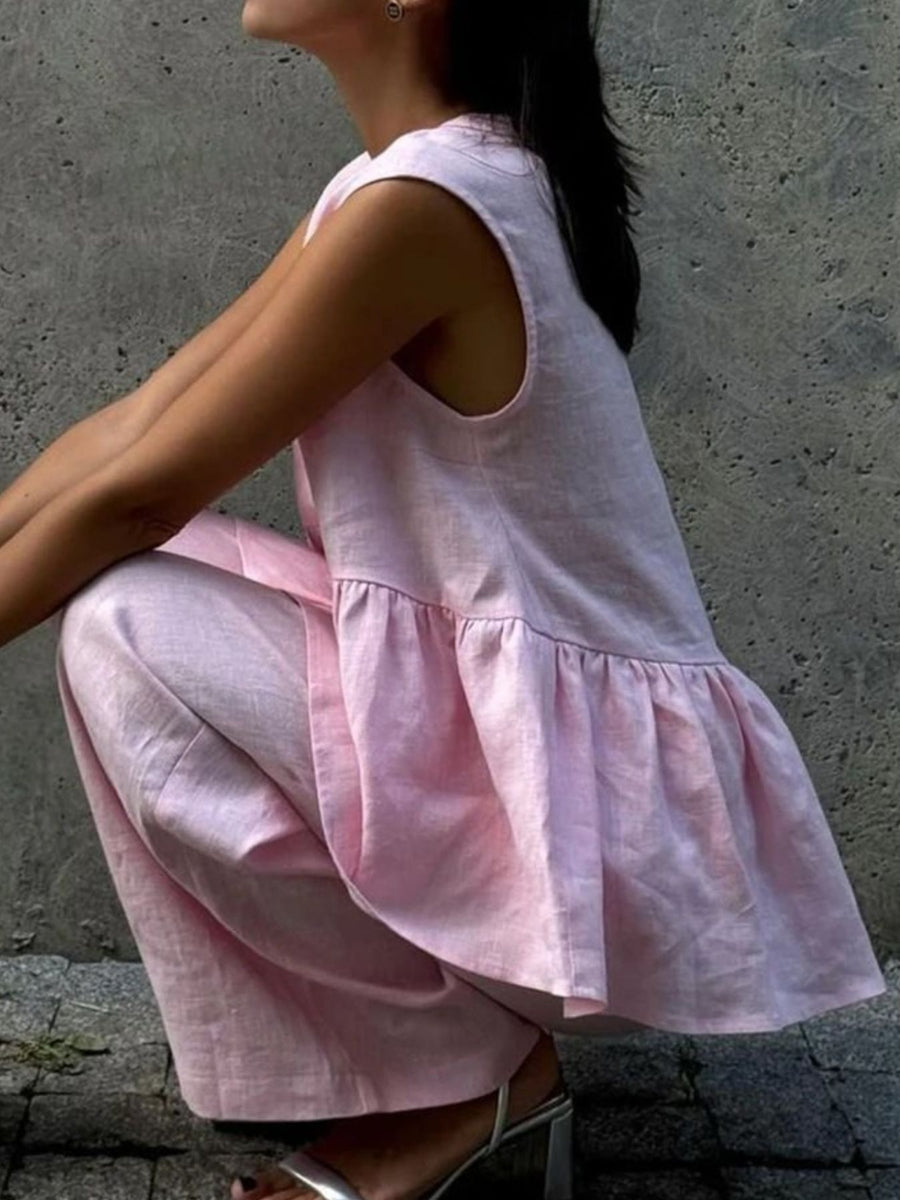 Blush pink sleeveless peplum top and wide-leg pants set in cotton.