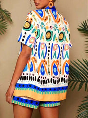Women's tropical print short sleeve cardigan and shorts set in white with blue, orange, and green abstract patterns.
