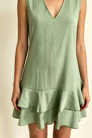 Sage green V-neck mini dress with tiered ruffle hem detail.