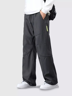 Men's gray loose fit cargo pants with drawstring and zip pocket detail.