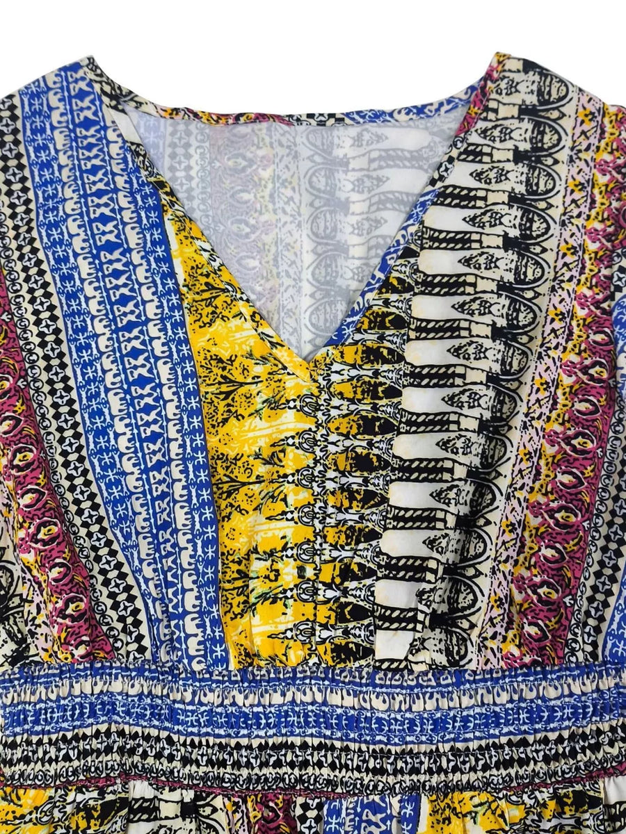 Bohemian maxi dress with V-neck, ruffle sleeves, and colorful tribal print.