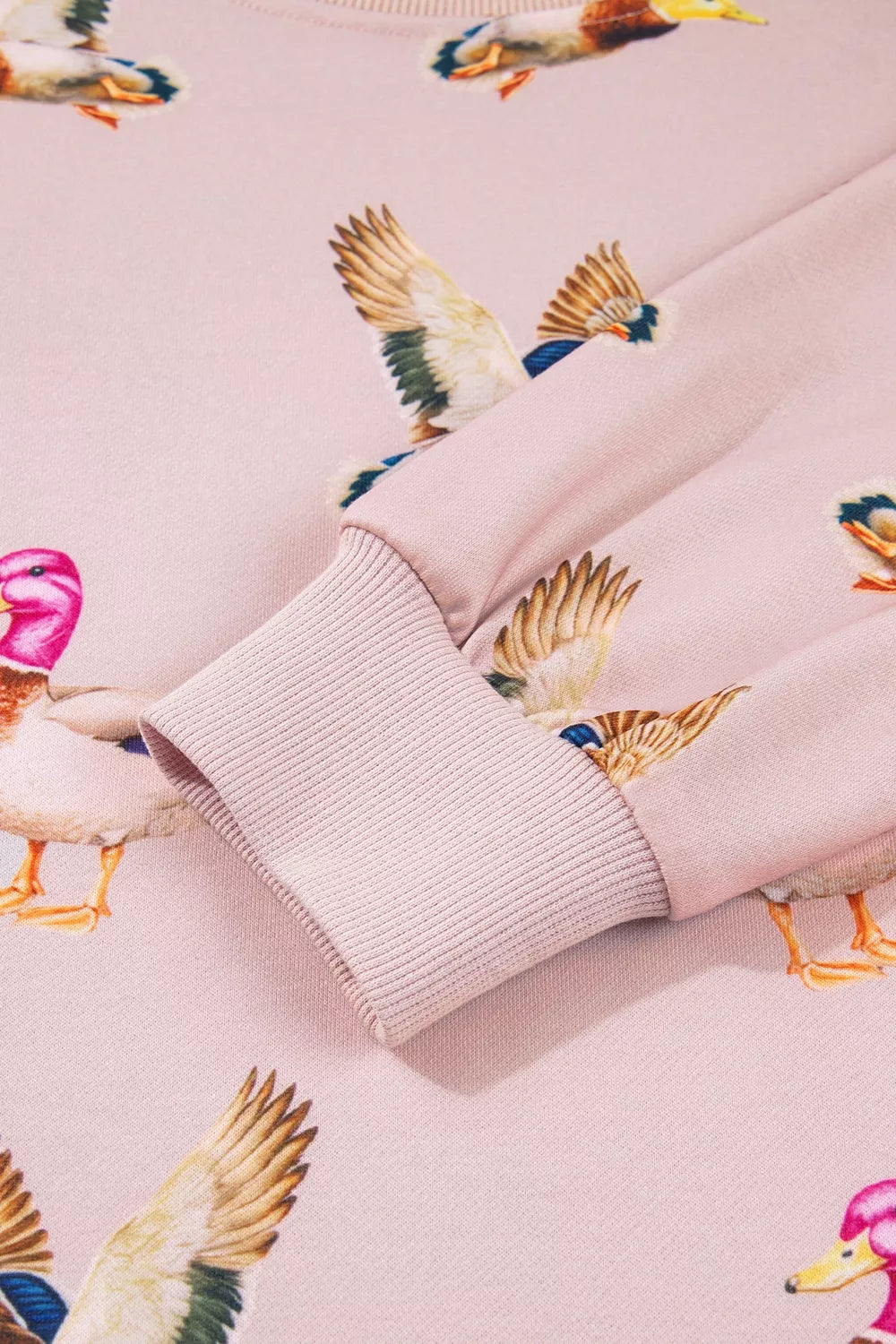 sweatshirt featuring duck-print in Blush Pink with 100% polyester Care instructions: Machine wash cold texture