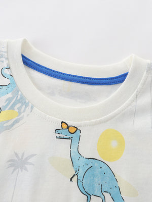 White toddler t-shirt with blue dinosaur print, sunglasses, and beach scene.