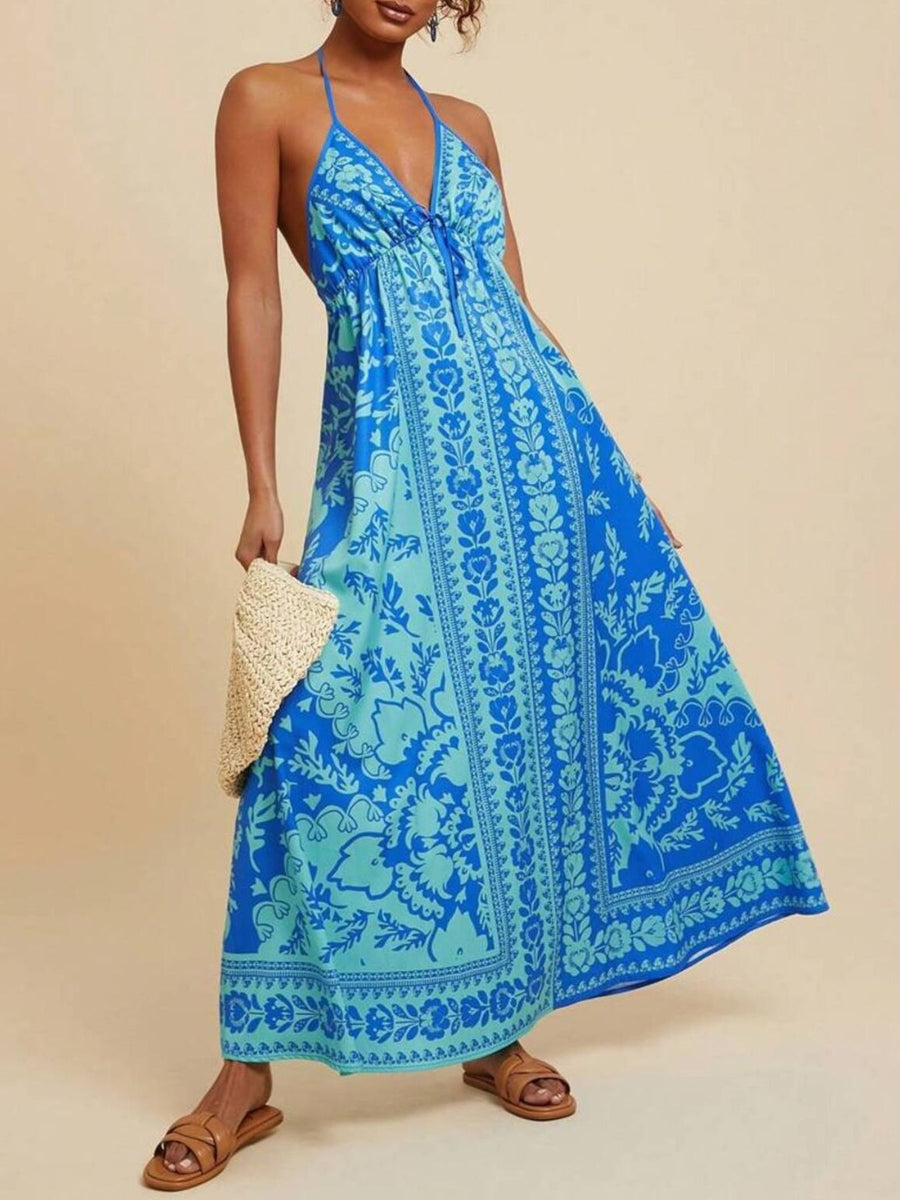 Blue floral halter maxi dress with tie front and flowing skirt.