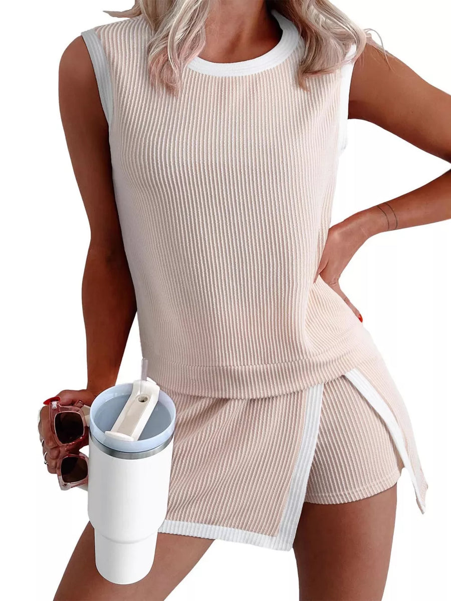 Ribbed knit sleeveless top and skort set in light khaki with white trim and side slits.