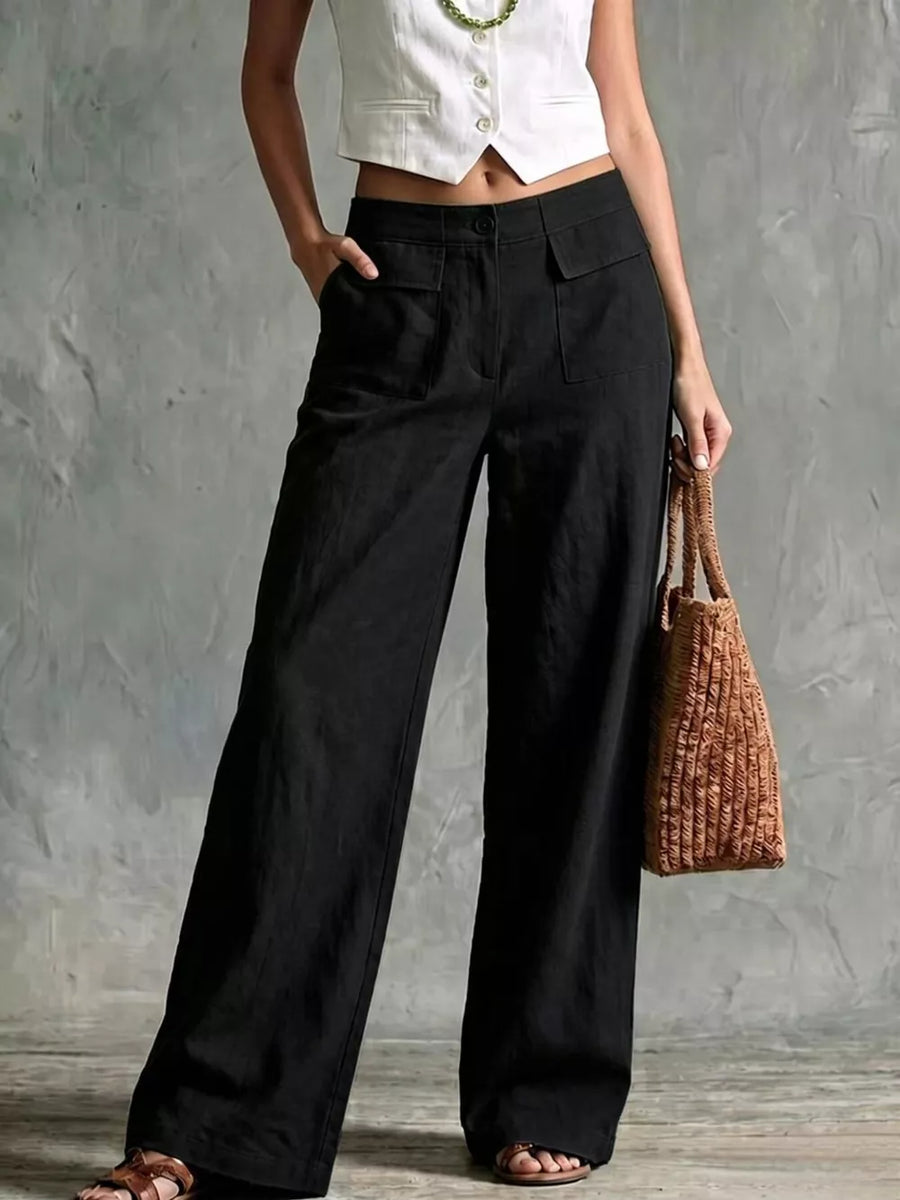 Black linen wide-leg pants with flap pockets and a button closure.