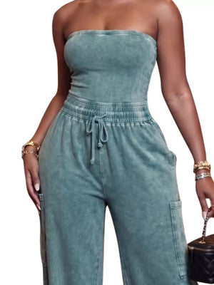 Strapless jumpsuit in washed teal cotton with drawstring waist and cargo pockets.