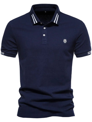 Navy polo shirt with striped collar and sleeve detail, featuring a textured knit and embroidered logo.