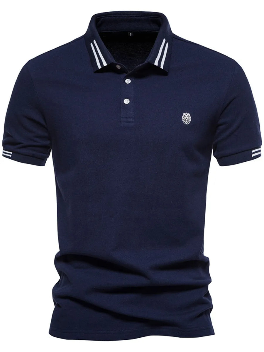 Navy polo shirt with striped collar and sleeve detail, featuring a textured knit and embroidered logo.