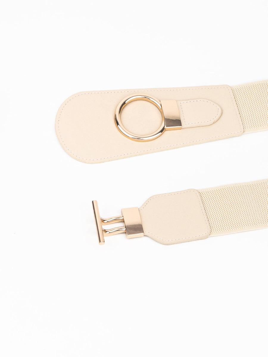 Cream elastic belt with sculpted gold hardware buckle and ring detail