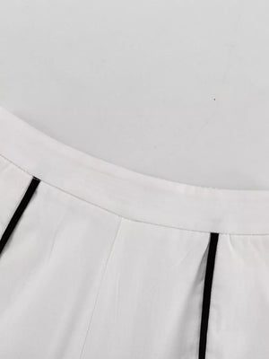 White wide-leg pants with black piping detail