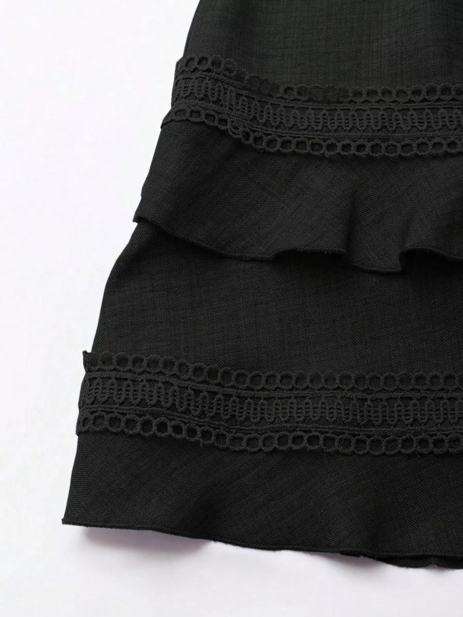 Black mini dress with tiered ruffles and lace trim detail