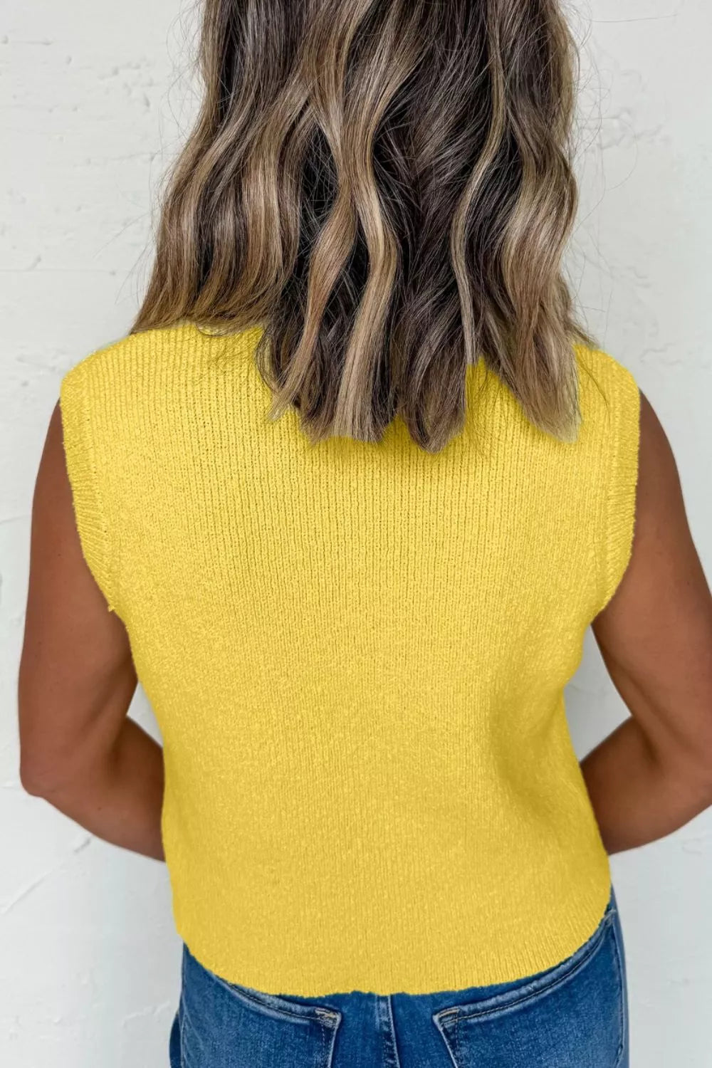 Yellow textured knit sweater vest with a button-down front, shown from the back.
