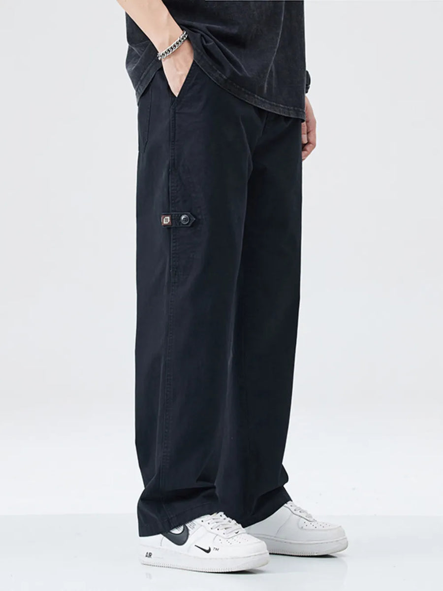 Black loose-fit cargo pants with utility details and button closure.