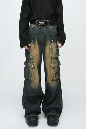 Faded wash oversized cargo jeans in dark blue denim with multiple button flap pockets and a baggy fit.