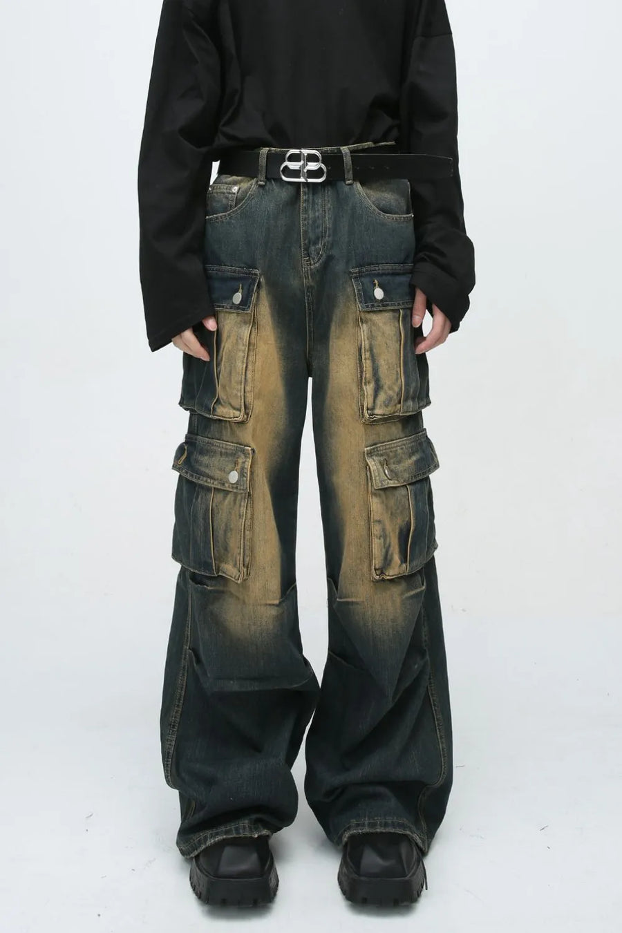 Faded wash oversized cargo jeans in dark blue denim with multiple button flap pockets and a baggy fit.