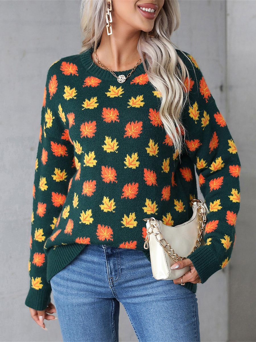 Dark Green knit crewneck sweater with all-over orange and yellow leaf pattern.