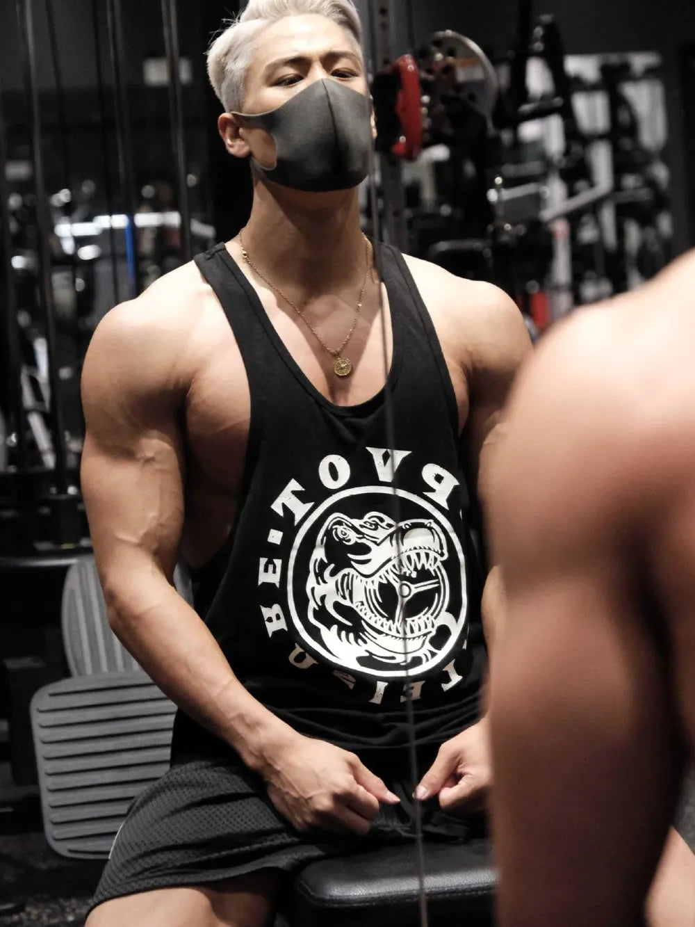 Black graphic muscle tank top with dinosaur print and racerback.