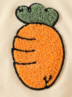 Baby set with orange carrot appliqué and green leaf detail on cream fabric.