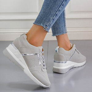 Grey lace-up wedge sneakers with metallic accents and perforated details.