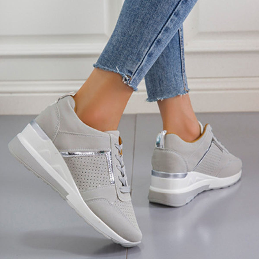 Grey lace-up wedge sneakers with metallic accents and perforated details.