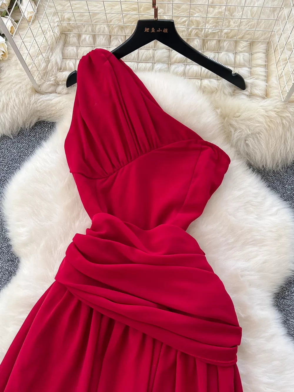 Red one-shoulder maxi dress with ruched detail and floral accents.