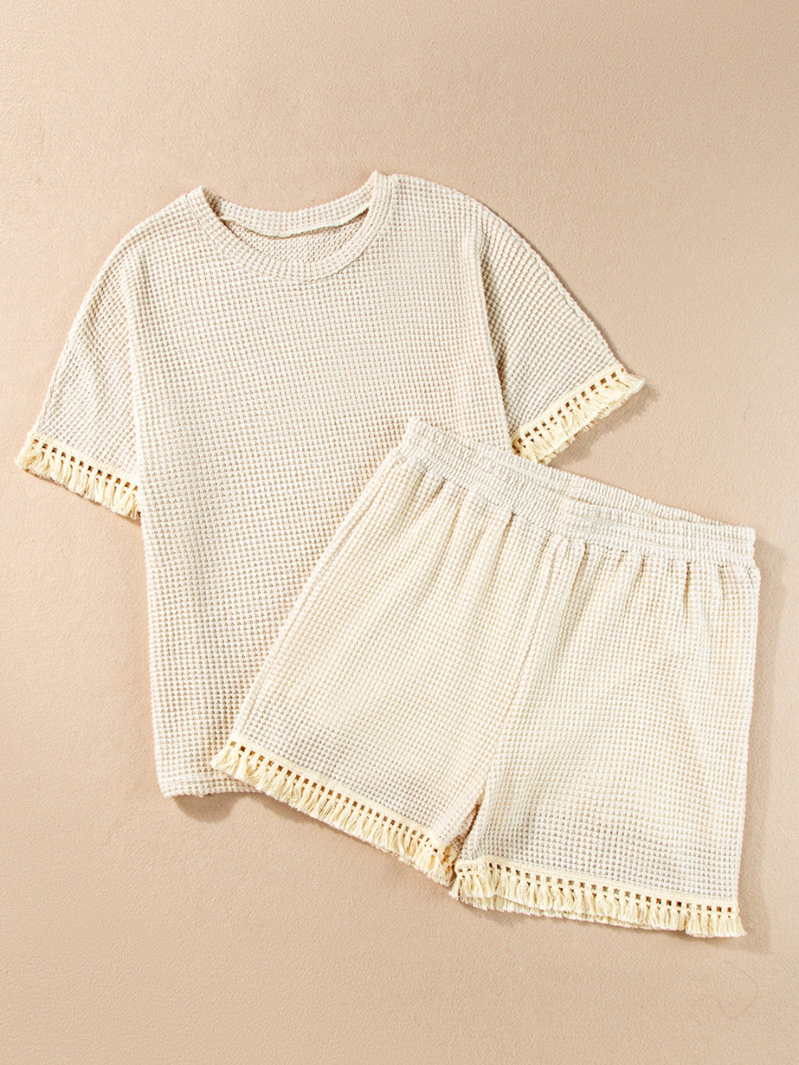 Cream waffle knit set with fringe trim on t-shirt sleeves and shorts hem.